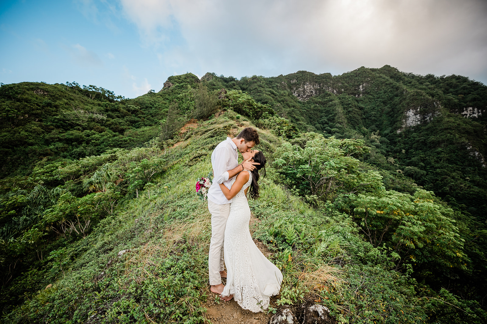 bride and groom kissing after getting married in mountains with hawaii elopement packages
