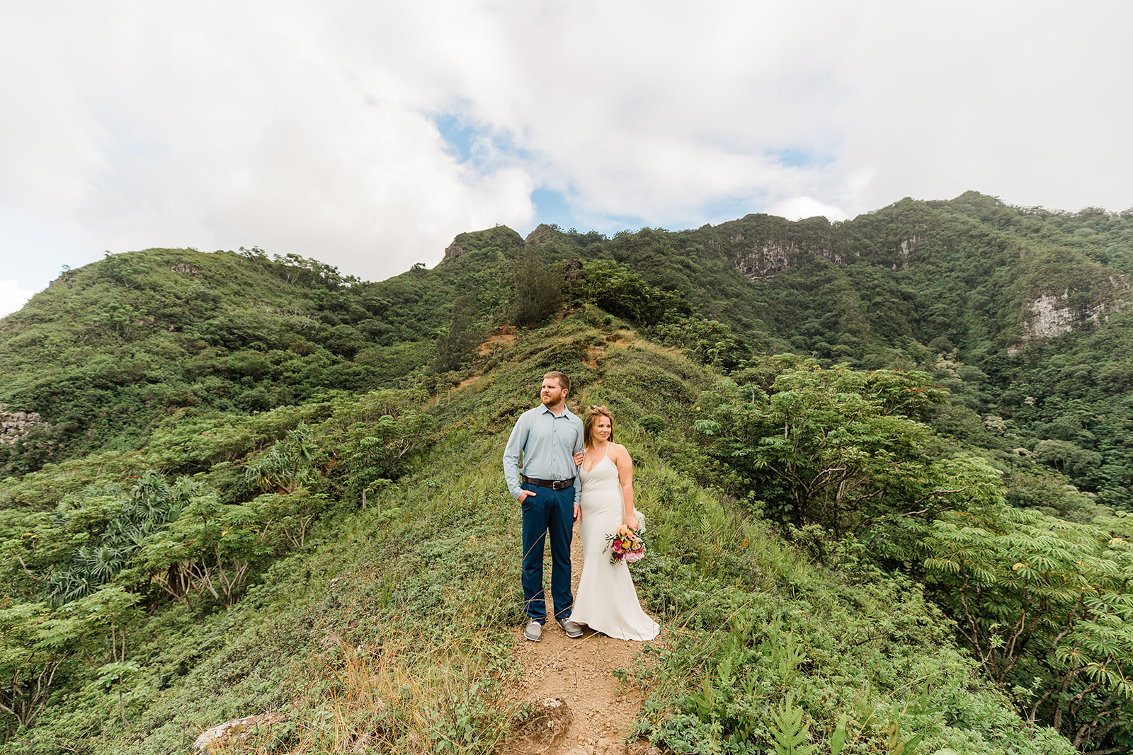 bride and groom standing in the mountain 