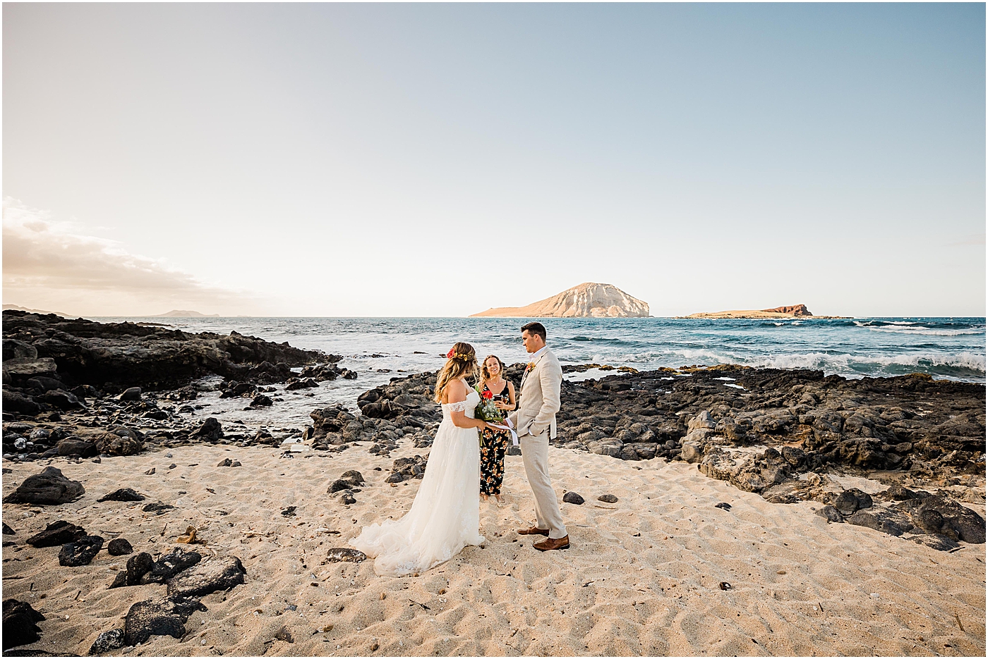 Bride and groom sharing vows in beach wedding in hawaii