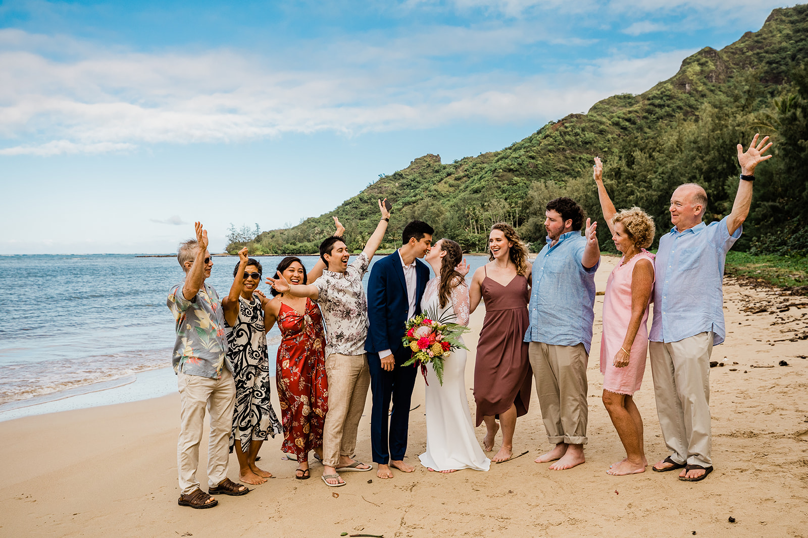 bride, groom, and family celebrating during hawaii elopement on the beach