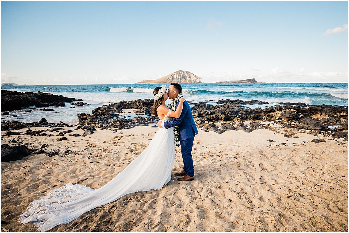 bride and groom first kiss during hawaii beach wedding
