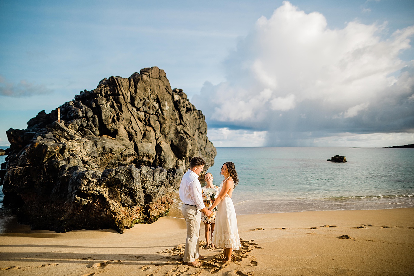 Haleiwa elopement ceremony with bride, groom, and officiant at the beach