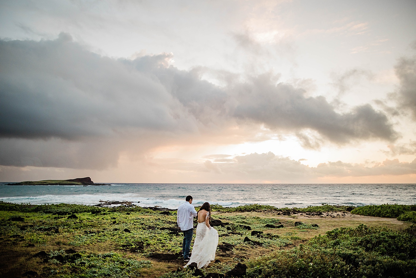 bride and groom walking to the beach at sunrise for their honolulu elopement