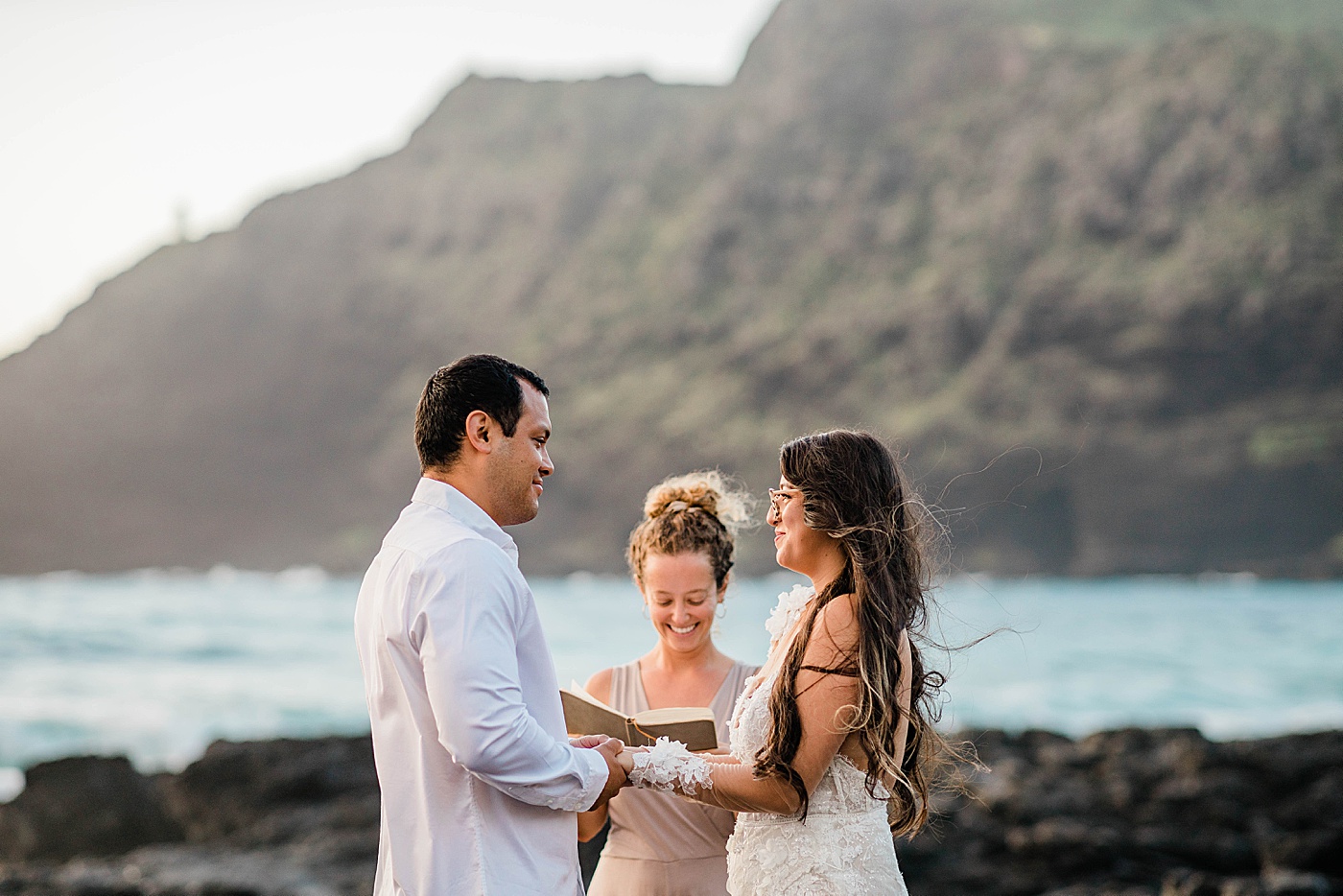 bride, groom, and officiant during honolulu elopement ceremony