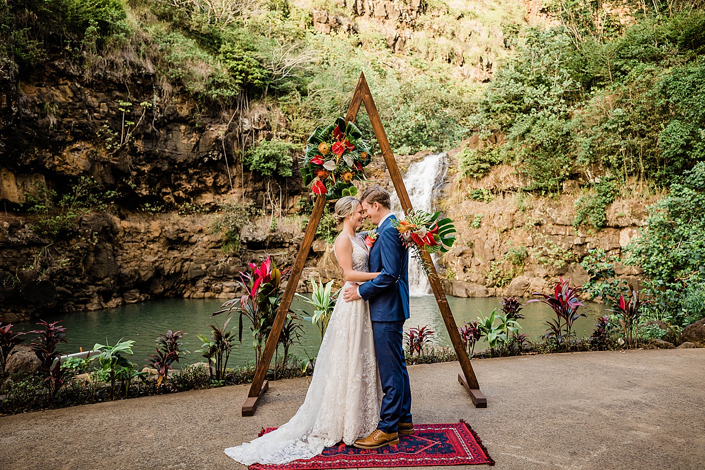 Bride and groom first kiss during Waimea Valley wedding ceremony.